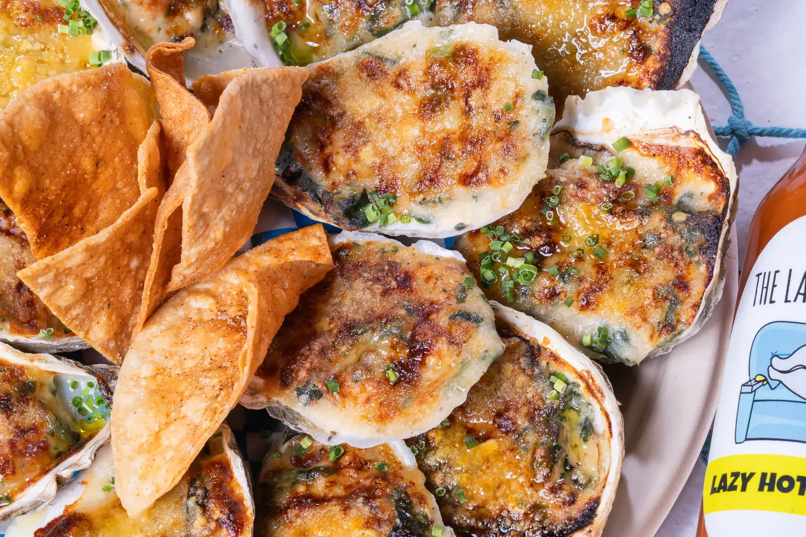 Chargrilled oysters with The Lazy Oyster hot sauce at a live event