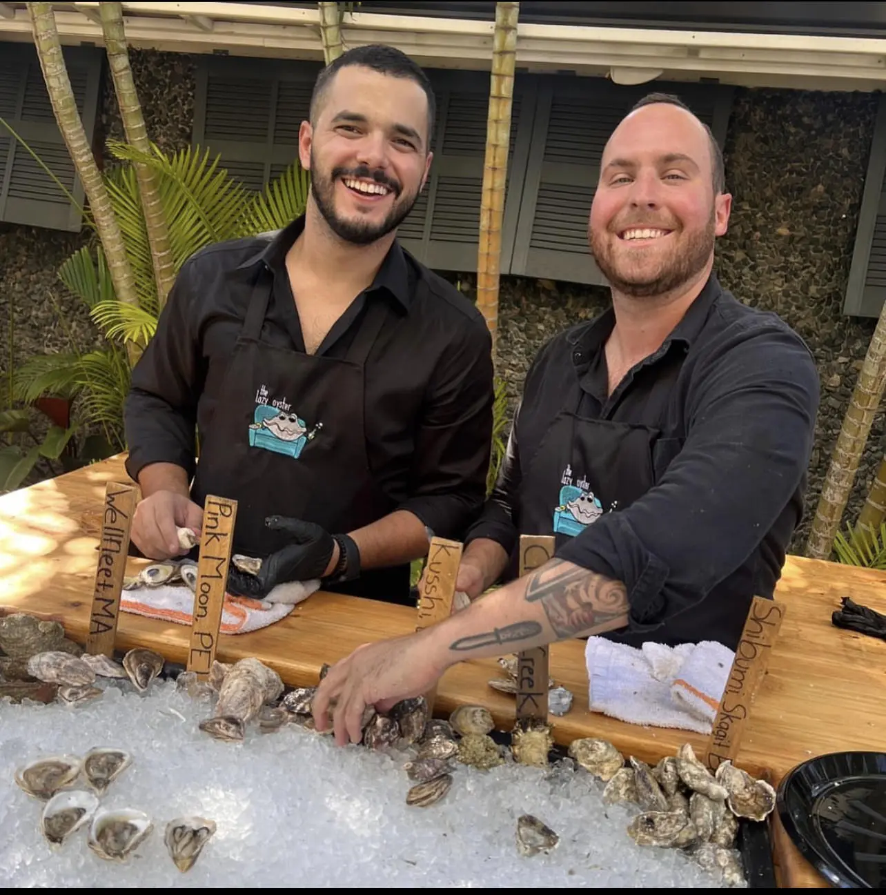 Alex Gilardi and Brandon Mesa, founders of The Lazy Oyster Miami, at their raw bar setup